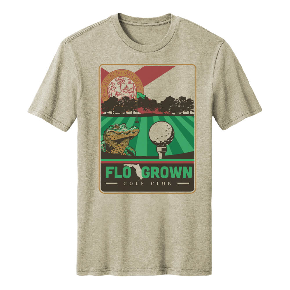 Beige t-shirt with a graphic design of a golf green and a gator with text 'FloGrown Golf Club'
