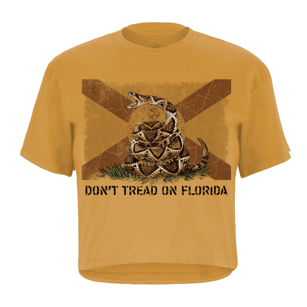 Front of a mustard women's crop top with the Gadsden flag and the Florida flag mashed up and text 'DON'T TREAT ON FLORIDA'
