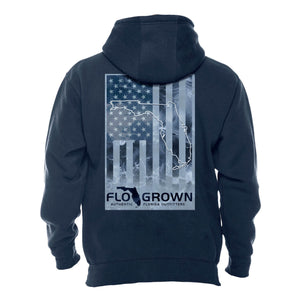 Navy hoodie with a vertical American flag in light blue with ocean design on the back.