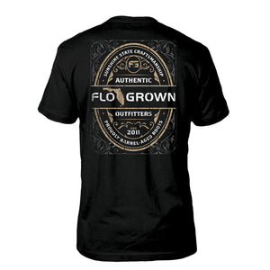 Black tee with a vintage graphic on the back in the style of a whiskey label with the FloGrown logo in the middle.
