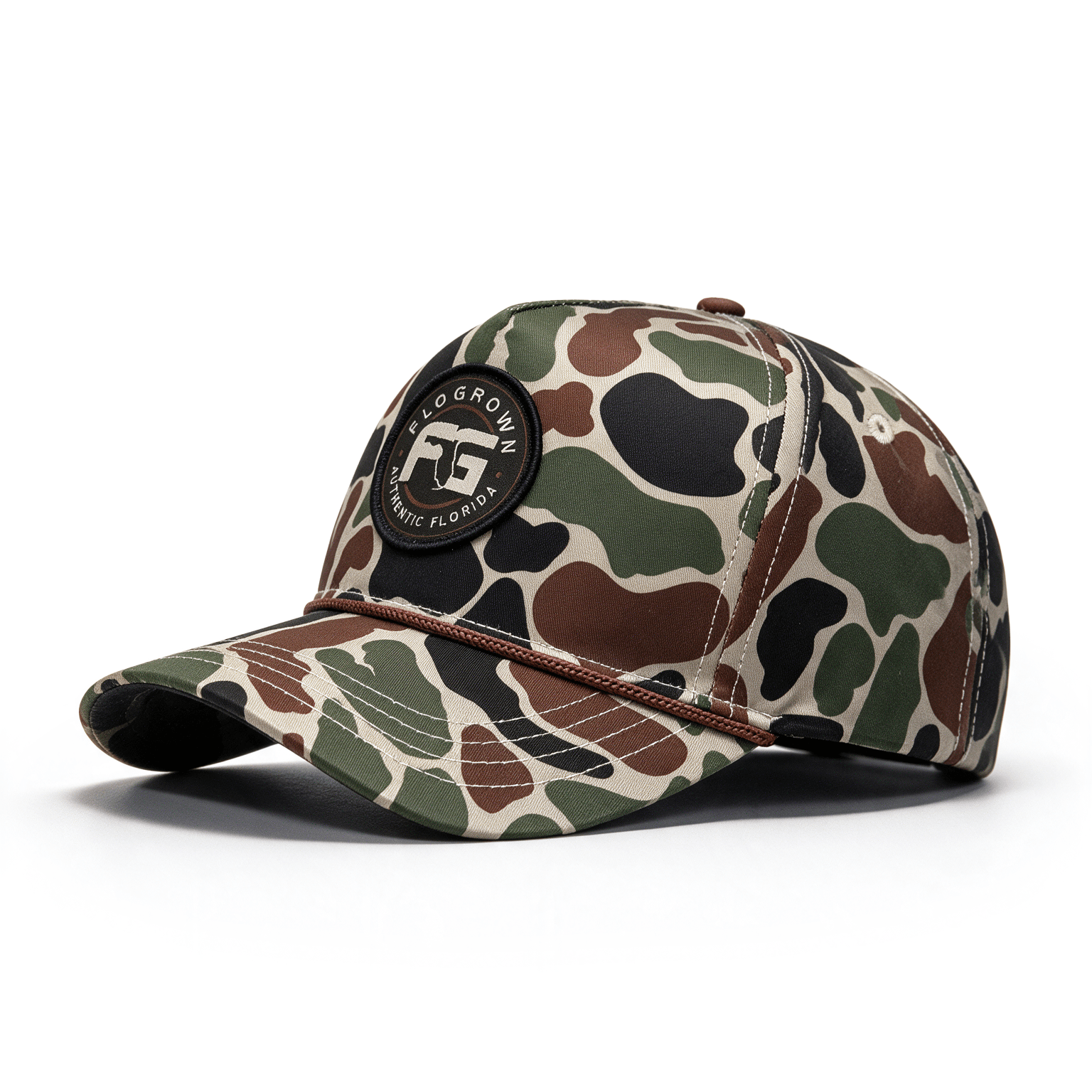 A camouflage baseball cap with a black circular patch on the front that reads 'FloGrown', shown on a clean white background.