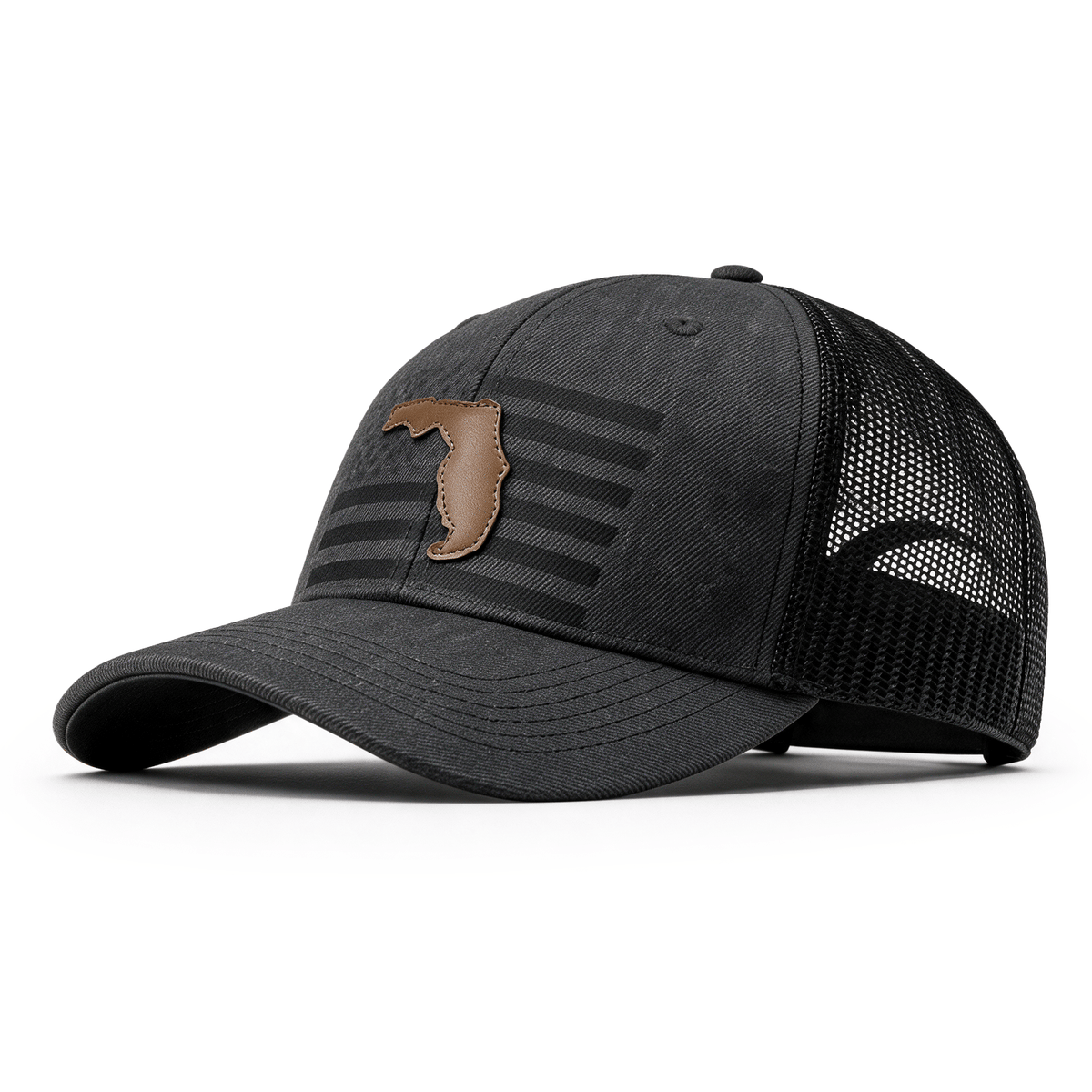 A dark gray trucker cap with a curved brim, black mesh back panels, and a brown leather patch on the front featuring the state of Florida.
