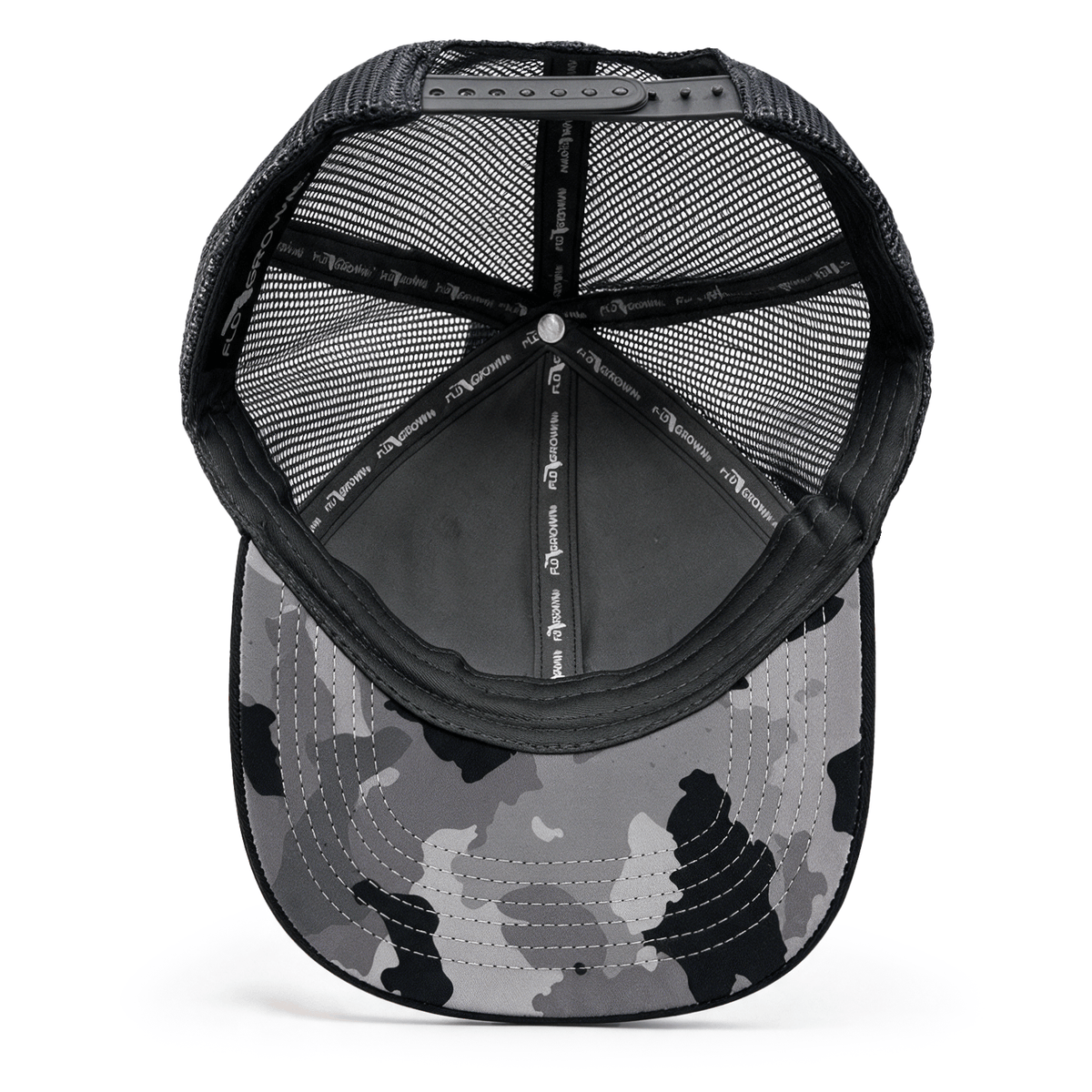 The underside of a black and gray camouflage trucker cap, showing the mesh back, and interior padding.