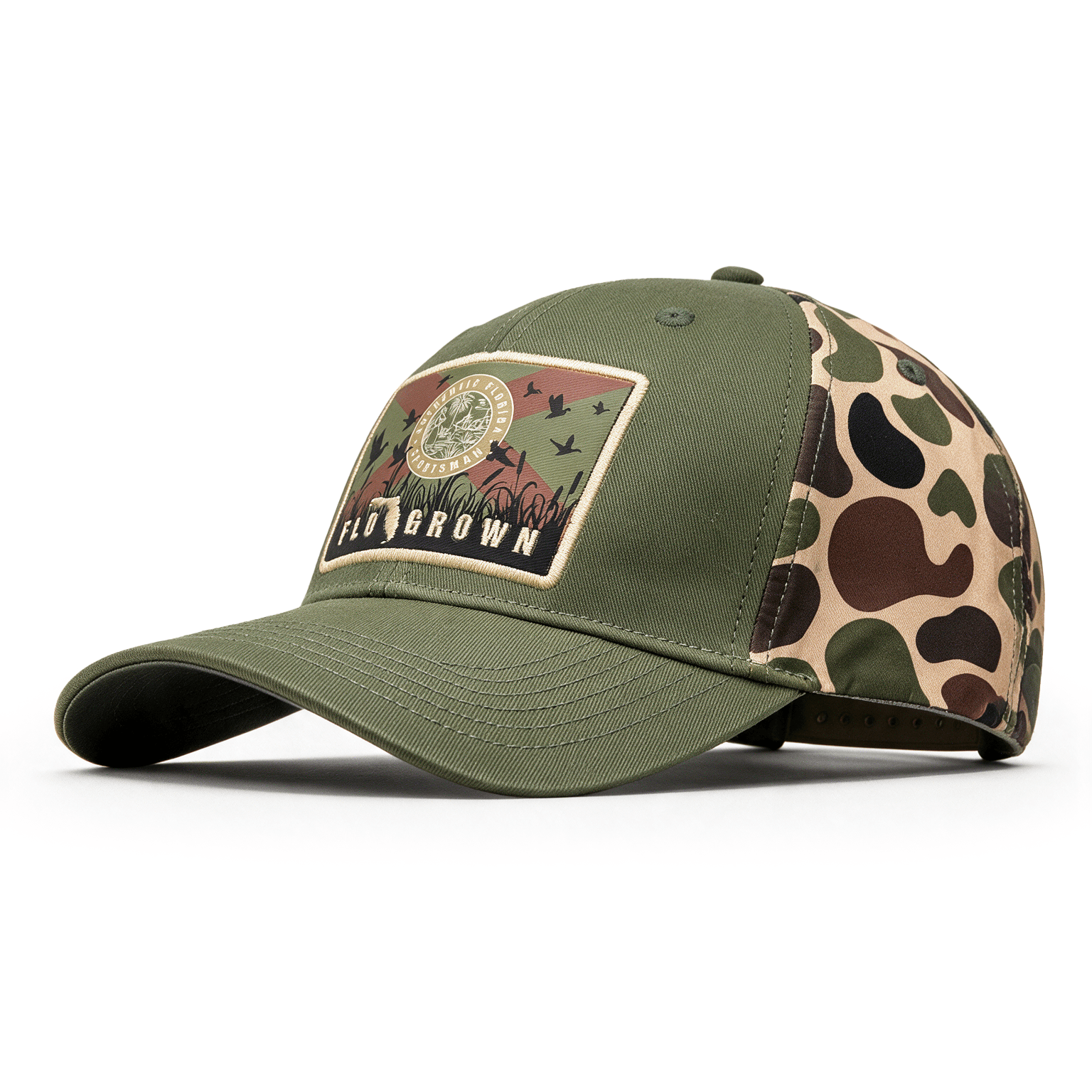An olive green baseball cap with a camouflage patterned side panel and a front patch with the FloGrown logo and the Florida flag.