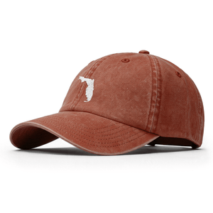 A red hat with a silver patch of the state of Florida on the crown. 