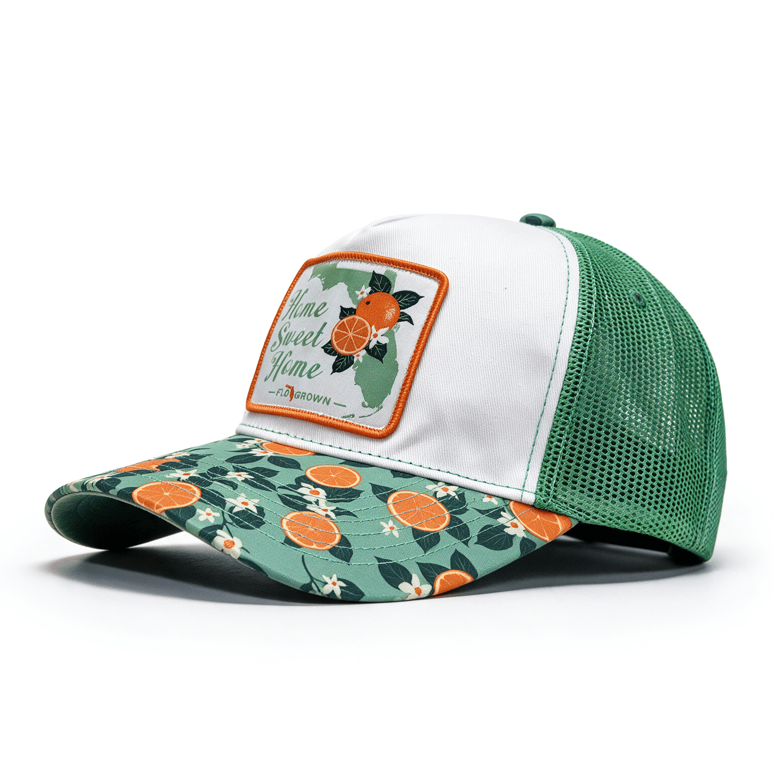 Trucker hat with floral and orange design on the visor with a white crown and a patch that says 