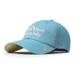 A light blue baseball cap with 'Sorta Sweet Sorta Salty' embroidered in white script and a gold outline of the state of Florida on the front. The underside of the brim is gold with a subtle pattern, and the side of the brim features a small gold embroidered logo.