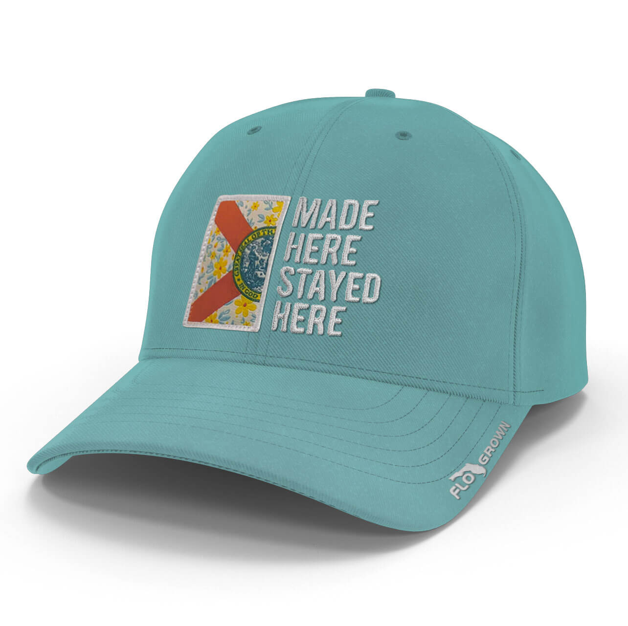 Light blue womens hat with half of a Florida flag on the left side in a floral pattern and the text 'MADE HERE STAYED HERE' on the right side.