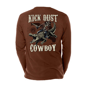 Brown long sleeve tee with a graphic of a skeleton riding a gator in a cowboy outfit with text 'KICK DUST COWBOY'.