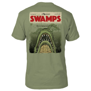 Green tee with a design of a poster on the back with the mouth of a gator coming out of the water and the title 'SWAMPS'.