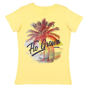 Yellow shirt with a graphic of a palm tree on the beach and two surfboards leaning against it.