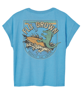 Blue shirt with a gator riding a wave on a surfboard on the back.