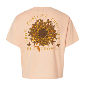Tan womens tee with a graphic of butterflies in the shape of a sunflower and text 'GROW POSITIVE THOUGHTS'.