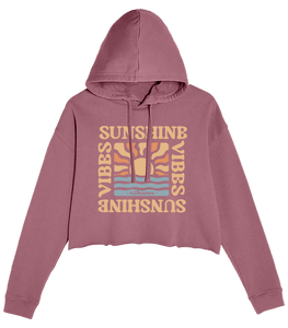 Pink cropped hoodie with retro text 'SUNSHINE VIBES' and sunrise over ocean design.