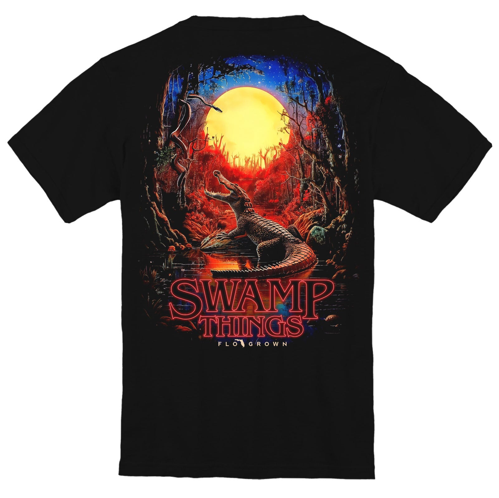 Black t-shirt with an alligator in the swamp with a full moon and red ambience and text 'SWAMP THINGS'.