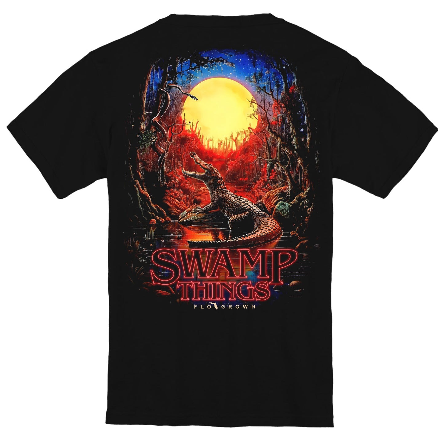 Black t-shirt with an alligator in the swamp with a full moon and red ambience and text 'SWAMP THINGS'.