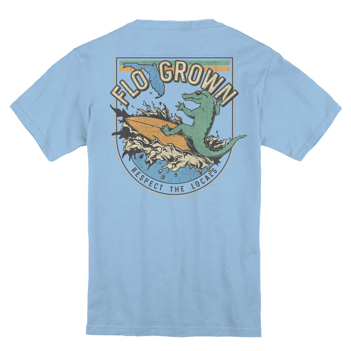 Light blue t-shirt with a graphic design of an alligator riding a surfboard. 
