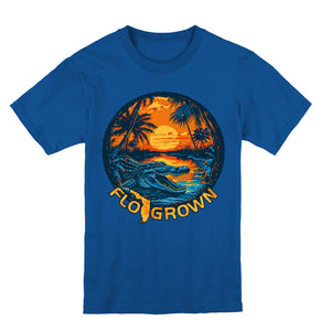 Blue youth tee with a circle sunset crest with an alligator and the FloGrown logo.