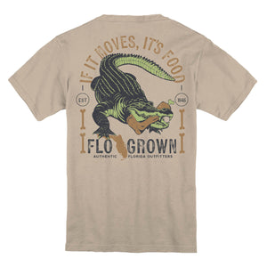 Beige t-shirt with a graphic of a alligator with a foot in its mouth and text 'IF IT MOVES, IT'S FOOD'.