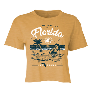 Yellow crop top with 'Welcome to Florida' graphic design featuring a woman, alligator, and palm trees.