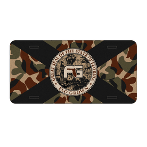 Camouflage-patterned license plate with a black and white Florida flag in the center.