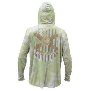 The back view of a long-sleeve hooded shirt with a light green and white tropical palm tree pattern, featuring a large graphic on the back with a gold and gray American flag design, and a Florida flag.
