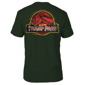 Green graphic tee with a yellow circle and a red background within with a gator skeleton and the text 'REDNECK SWAMP PARK'.